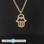 Load and play video in Gallery viewer, 14KT Yellow Gold Hamsa Necklace w/ Sapphire Eye
