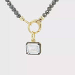 Load and play video in Gallery viewer, Two-Tone Gold-Plated Beaded Necklace with Emerald-Cut Crystal Pendant
